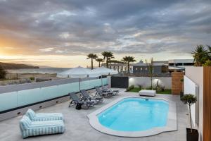 a swimming pool on the roof of a building at AZURE Seaside Residence in Kokkini Khanion