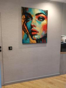 a painting of a woman on a wall at Centro Residence in Kluczbork