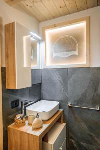 a bathroom with a sink and a mirror at Country Life Chalet in Tione di Trento +58 photos