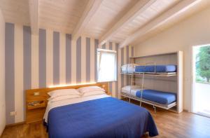a bedroom with a bed and two bunk beds at Bellafiora Affittacamere in Osimo