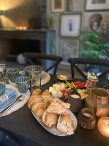 a table with plates of pastries and other food on it at Dreamhome B&B Limoux in Limoux