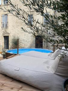 a mattress sitting in front of a swimming pool at Dreamhome B&B Limoux in Limoux