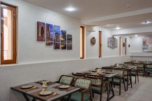 a row of tables and chairs in a restaurant at SHakhina premium hotel in old city in Bukhara