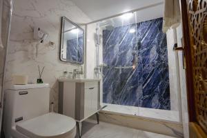 a bathroom with a toilet and a glass shower at SHakhina premium hotel in old city in Bukhara +81 photos