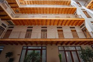 an external view of a building with a balcony at SHakhina premium hotel in old city in Bukhara