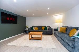 a living room with a couch and a table at Durham 5BR Contractors Long Stay Discounts in Murton