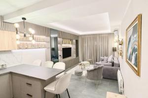a kitchen and living room with a couch and a table at Varja 3 Apartment in Pržno