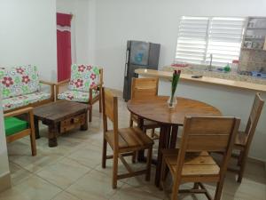 a room with a table and chairs and a kitchen at MK apartment in Las Terrenas