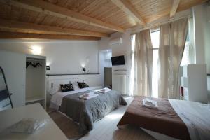 a bedroom with two beds and a large window at Mosahouse in Naples