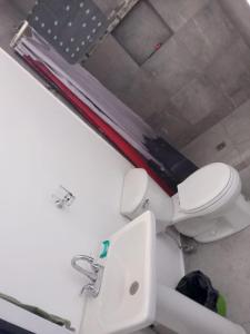 a bathroom with a toilet and a sink at SN2 Loft for 2 people, private bathroom in Monterrey