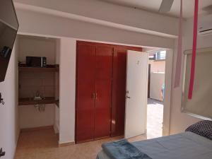 a bedroom with a red closet and a red door at SN2 Loft for 2 people, private bathroom in Monterrey +7 photos