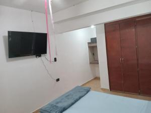 a room with a flat screen tv hanging on a wall at SN2 Loft for 2 people, private bathroom in Monterrey