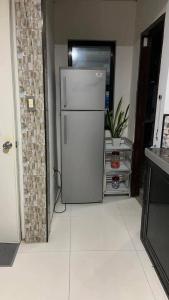 a kitchen with a refrigerator in a room at Digong Guest House Mulogan in Molugan