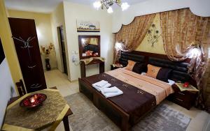 a bedroom with a large bed and a table at Relax pozar in Kato Loutraki