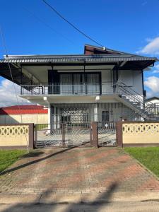 a house with a brick driveway in front of it at Villa Japandi in Paramaribo