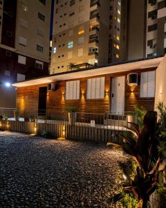a house with lights on the side of it at night at Loft Lux 4 Centro (Smart TV, ar-condicionado e cozinha completa) in Chapecó