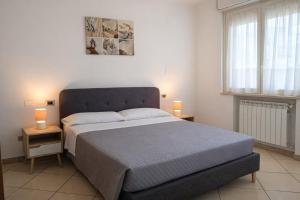 a bedroom with a large bed and two lamps on tables at Kai beach in Villa Rosa +16 photos