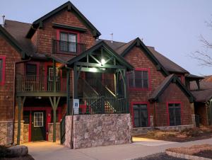 a large brick house with a balcony on it at Premium 3 Bed Top Floor Views in Vernon Township