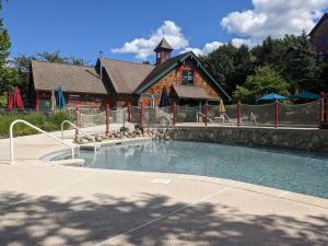 a swimming pool in front of a house at Premium 3 Bed Top Floor Views in Vernon Township