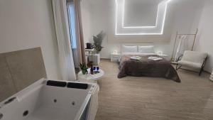a bedroom with a bed and a bath tub at Centrale Suites in Brindisi +34 photos
