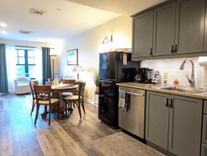 a kitchen with a table and a black refrigerator at Country Charm 1 Bd Balcony Views in Vernon Township