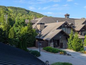 a large house with a mountain in the background at Country Charm 1 Bd Balcony Views in Vernon Township
