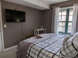 a bedroom with a bed and a tv on the wall at Mt. Slope Great View 1 Bed Condo in Vernon Township +16 photos