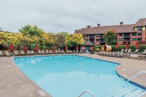 a large swimming pool with chairs and a hotel at Mt. Slope Great View 1 Bed Condo in Vernon Township