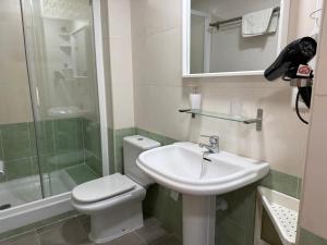a bathroom with a sink and a toilet and a shower at Rentalmar Costa Verde in Cambrils