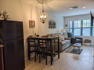 a kitchen and living room with a table and a refrigerator at All New Chic Ski inout King bed in Vernon Township