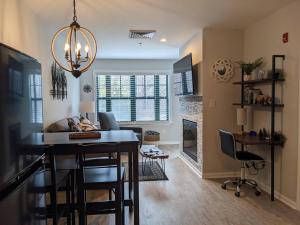 a dining room and living room with a table and chairs at All New Chic Ski inout King bed in Vernon Township