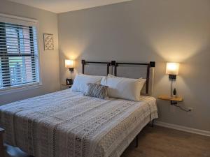 a bedroom with a bed with two lamps and a window at All New Chic Ski inout King bed in Vernon Township +12 photos