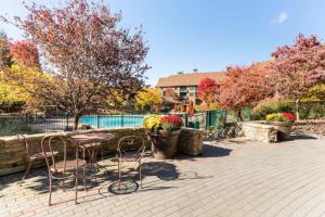 a patio with a table and chairs and a pool at All New Chic Ski inout King bed in Vernon Township