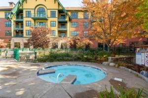 a building with a pool in front of a building at All New Chic Ski inout King bed in Vernon Township