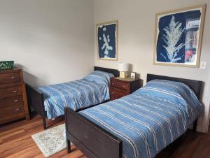 a bedroom with two beds and a dresser at Country Chic New 2 Bed 2 Bath in Vernon Township +18 photos