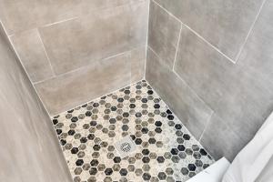 a bathroom with a shower with a drain at Boutique Hotel Style Steps to Boardwalk in Seaside Heights