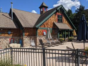 a building with chairs and umbrellas in front of it at Country Chic New 2 Bed 2 Bath in Vernon Township