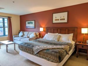 a bedroom with a large bed and a couch at Slope side cozy Studio in Vernon Township +18 photos