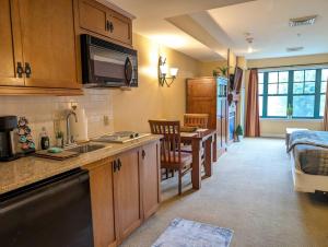 a kitchen with a sink and a table in a room at Slope side cozy Studio in Vernon Township