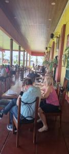 a group of people sitting at tables in a restaurant at Ambigua Hospedaje in Trujillo