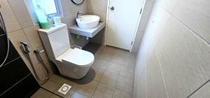 a bathroom with a white toilet and a sink at Master Room with Private Bath at Kajang in Kajang