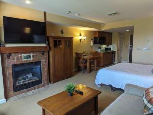 a hotel room with a bed and a fireplace at Rustic classic spacious Studio in Vernon Township