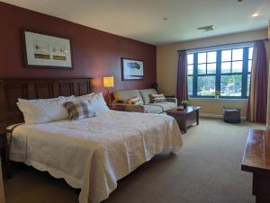 a bedroom with a large bed and a couch at Rustic classic spacious Studio in Vernon Township