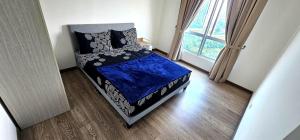 a small bed in a room with a window at Master Room with Private Bath at Kajang in Kajang