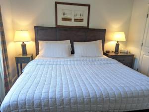 a bedroom with a large bed with two lamps on tables at Great Views 2 Bed 2 Bath Updated in Vernon Township