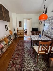 a living room with a table and a dining room at Balatonlak in Ábrahámhegy