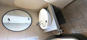 a bathroom with a mirror and a sink at Master Room with Private Bath at Kajang in Kajang