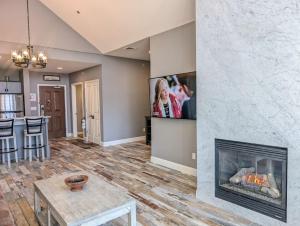 a living room with a fireplace and a tv on a wall at 2 Bed Top Flr Prem Penthouse Suite in Vernon Township