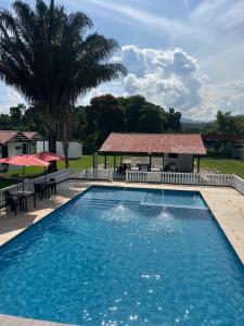 a large swimming pool with a gazebo at Shaddai Villeta Centro Ecoturistico in Villeta