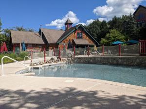 a house with a swimming pool in front of a building at Spacious 3 bed 2 bath Sanctuary in Vernon Township